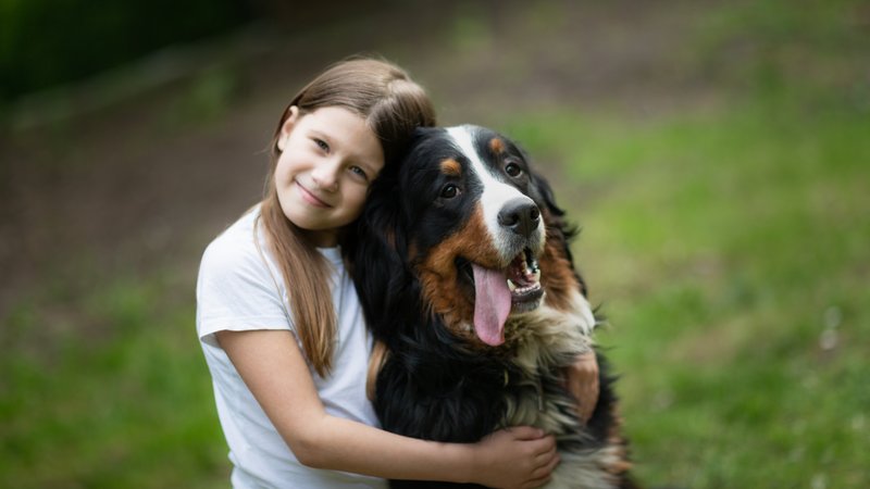 child hugging dog