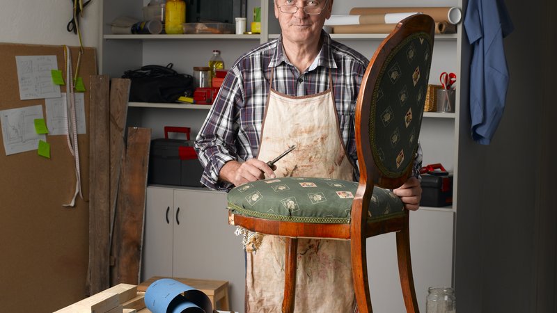 elderly man crafting furniture