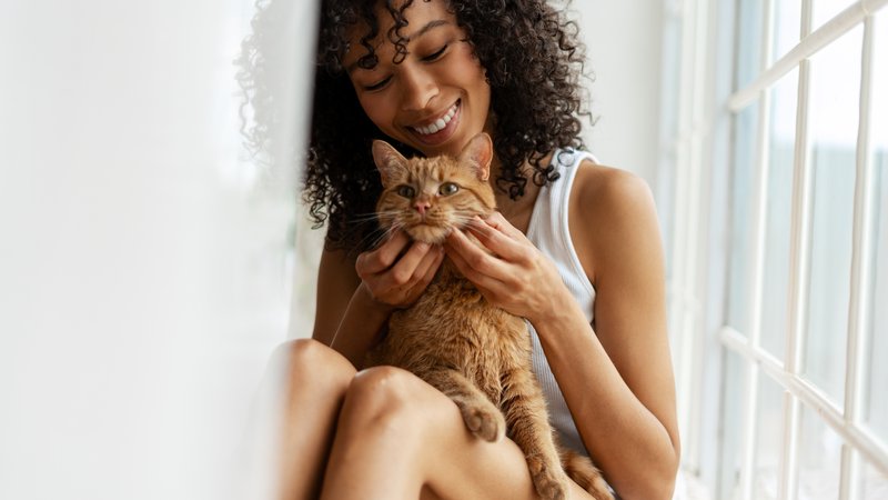 woman petting cat