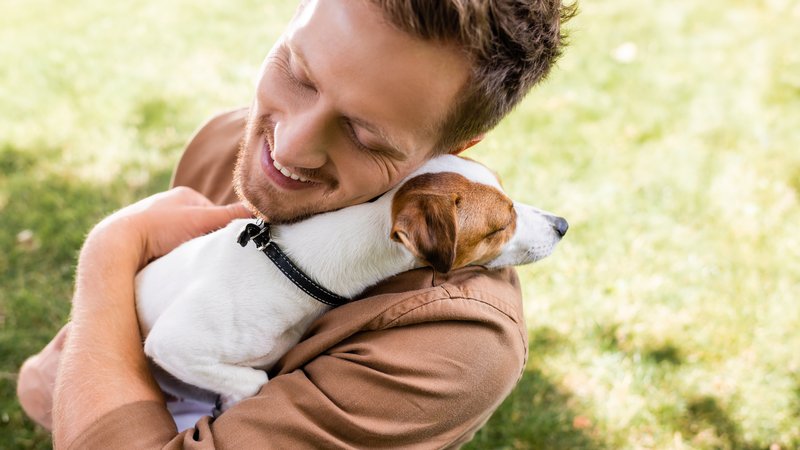 man and puppy outdoors