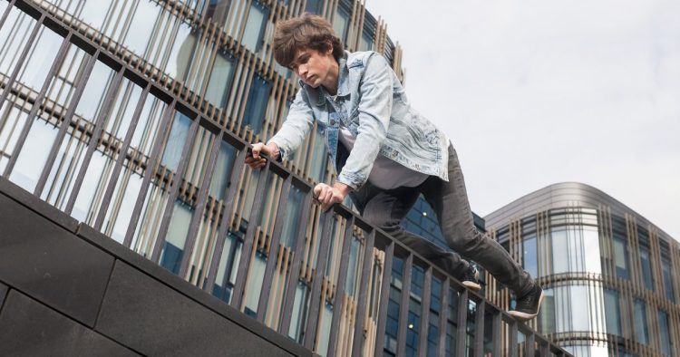boy climbing building
