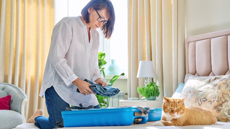 cat owner preparing for vacation